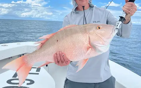 Angler holding a snapper caught on a Key West fishing charter